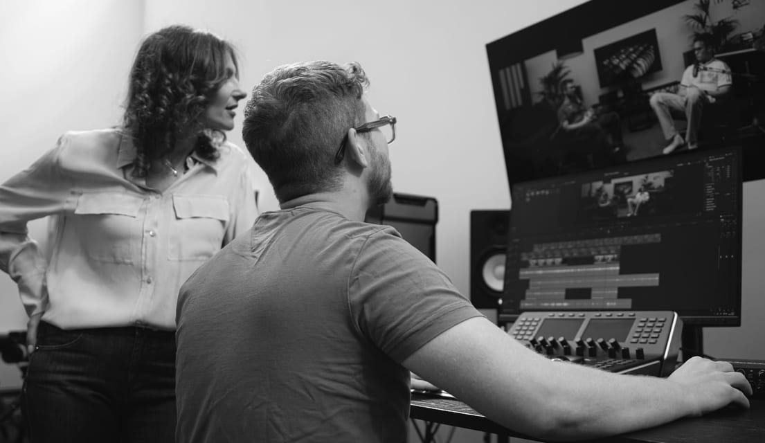 A working session at a client's editing desk, reviewing a project on screen.